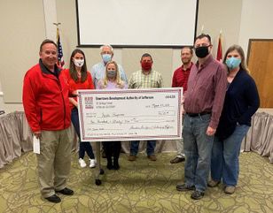 DDA presents check